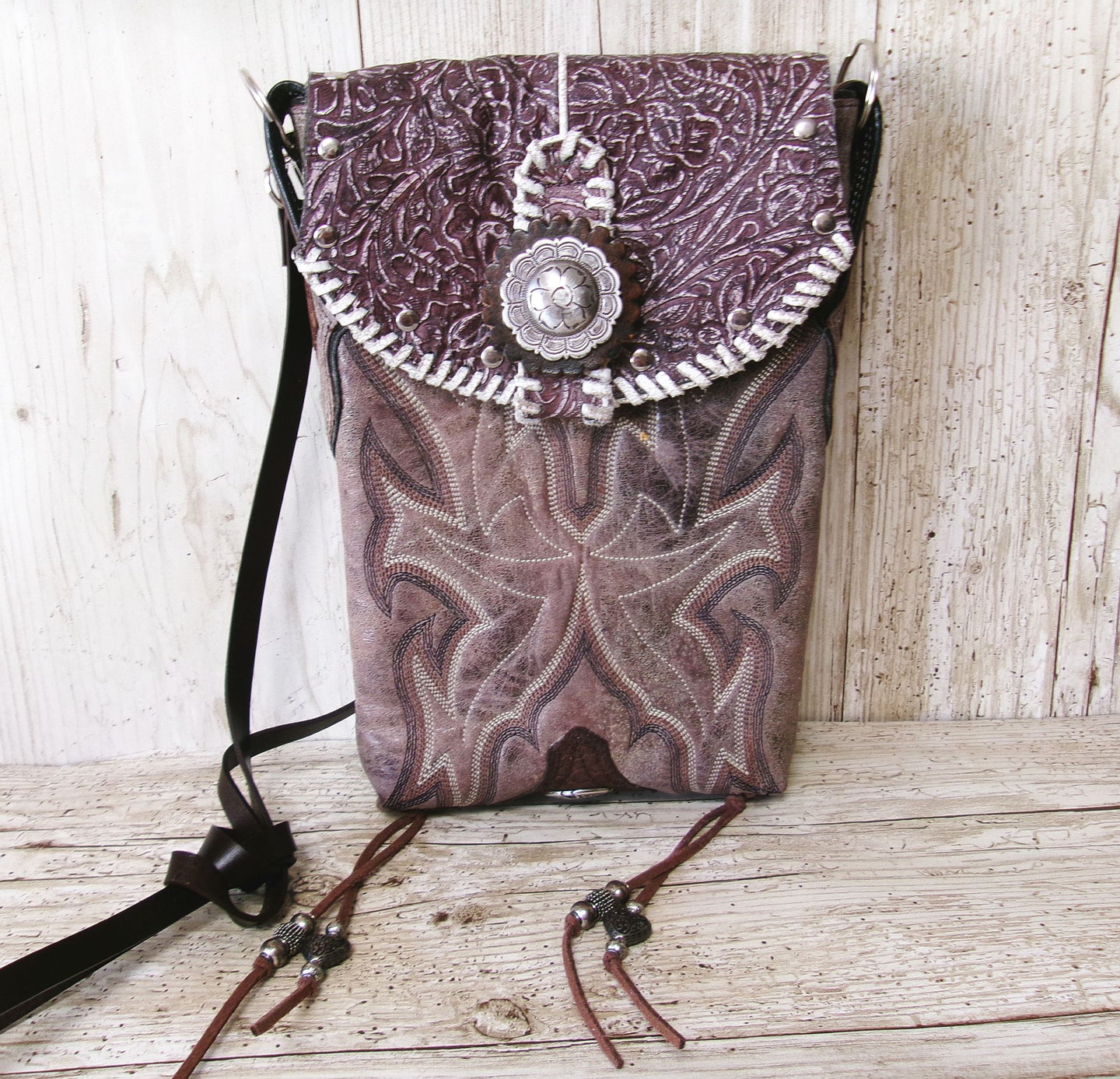 Purple patterned bag with decorative elements on a wooden surface